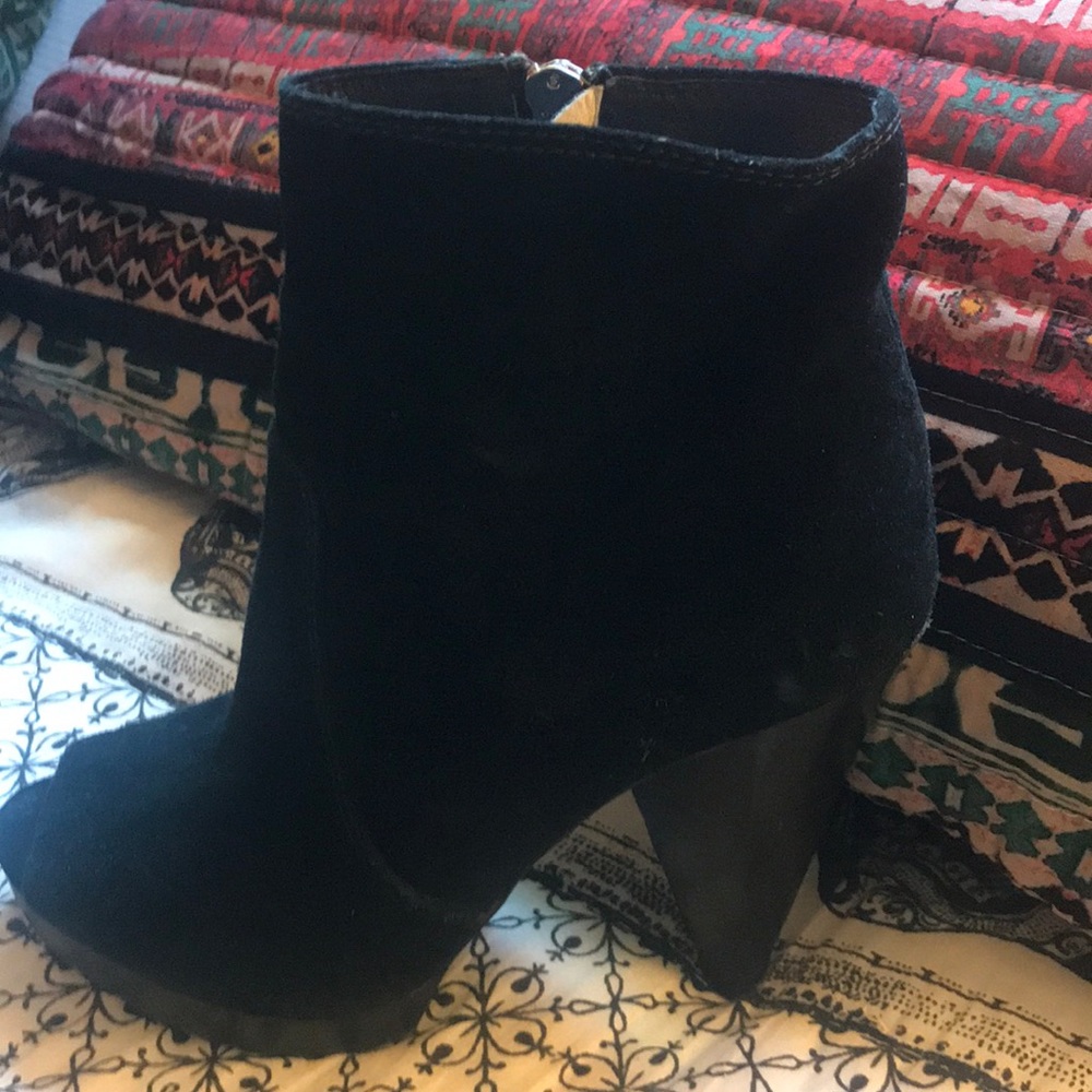 Black booties with angled heel.